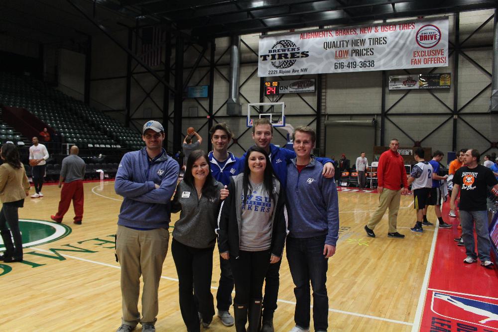 Six staff members on the basketball court for the Grand Rapids Drive